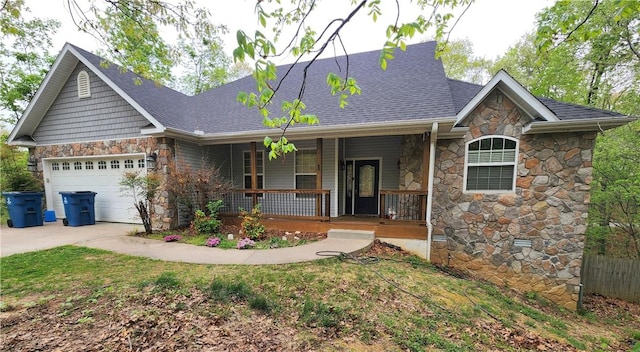 1 Binham Ln, Bella Vista, AR 72715 - view of front of house featuring stone siding, covered porch, driveway, an attached garage, and fence