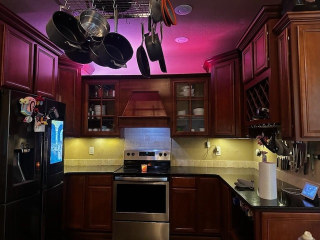 1 Binham Ln, Bella Vista, AR 72715 - kitchen with black fridge, stainless steel range with electric stovetop, custom exhaust hood, and dark brown cabinets