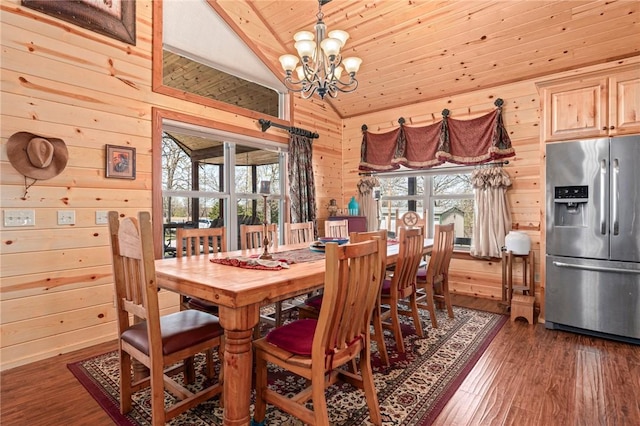 95951 Manns Dr, Gore, OK 74435 - dining area featuring wood finished floors, vaulted ceiling, wood walls, and a chandelier