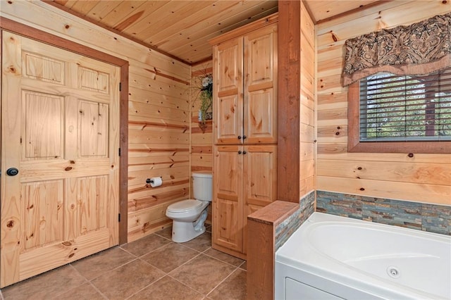 95951 Manns Dr, Gore, OK 74435 - full bathroom featuring tile patterned floors, wood walls, a jetted tub, and toilet