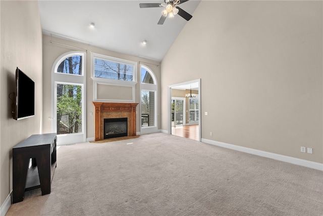 3902 NE Cadbury Ave, Bentonville, AR 72712 - unfurnished living room with high vaulted ceiling, a fireplace with flush hearth, ceiling fan, baseboards, and light colored carpet