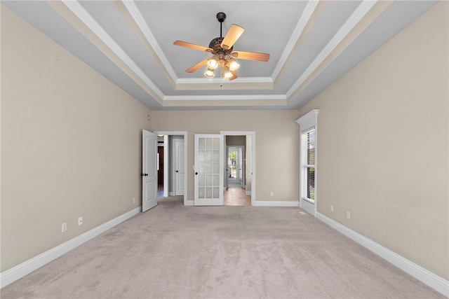 3902 NE Cadbury Ave, Bentonville, AR 72712 - unfurnished bedroom featuring light colored carpet, a tray ceiling, french doors, ornamental molding, and baseboards