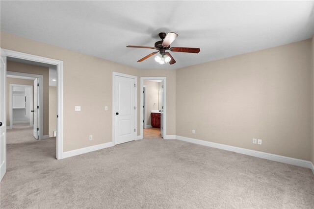 3902 NE Cadbury Ave, Bentonville, AR 72712 - unfurnished bedroom featuring light carpet, baseboards, ensuite bath, and a ceiling fan