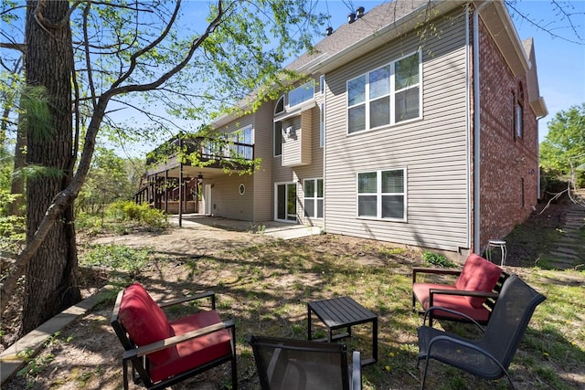 3902 NE Cadbury Ave, Bentonville, AR 72712 - rear view of property with a patio area, a deck, and brick siding