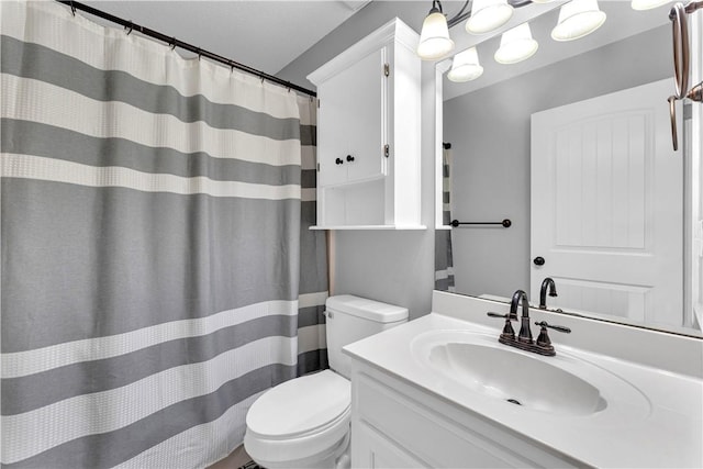 full bathroom featuring toilet, vanity, and curtained shower