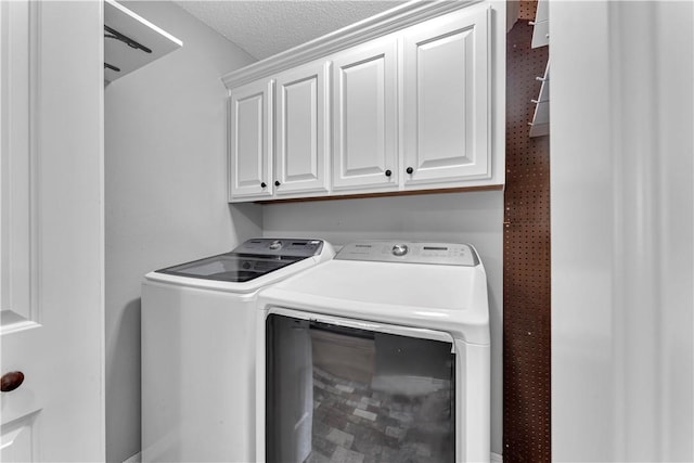 laundry room with separate washer and dryer and cabinet space