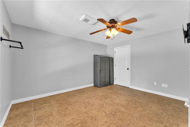 empty room featuring a ceiling fan, baseboards, and a textured ceiling
