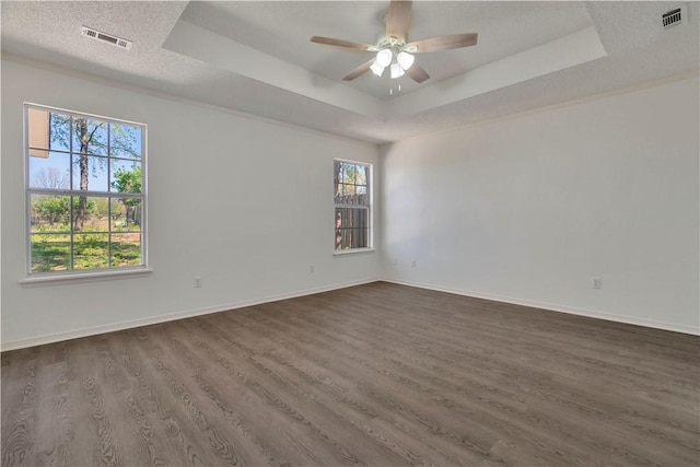 1762 Oxford Pl, Springdale, AR 72764 - unfurnished room with a tray ceiling, dark wood-type flooring, a ceiling fan, baseboards, and a textured ceiling
