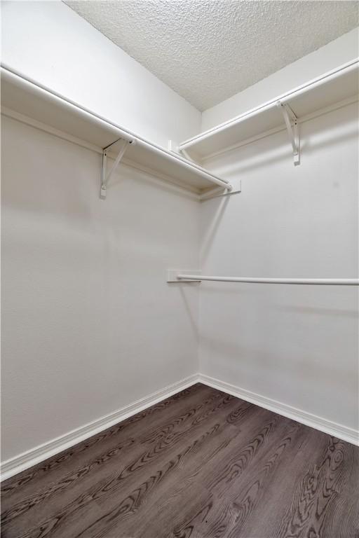 1762 Oxford Pl, Springdale, AR 72764 - walk in closet with dark wood-style floors