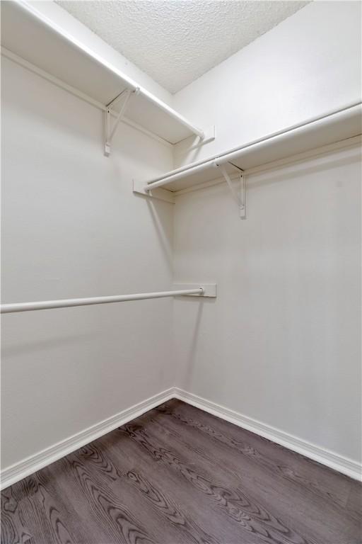 1762 Oxford Pl, Springdale, AR 72764 - walk in closet with dark wood finished floors