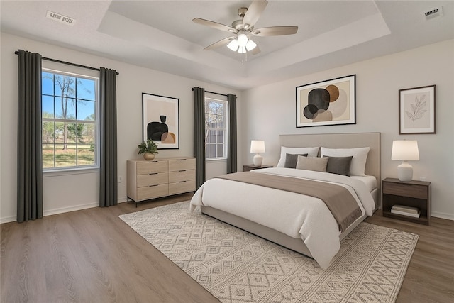 1762 Oxford Pl, Springdale, AR 72764 - bedroom with a raised ceiling, wood finished floors, baseboards, and ceiling fan