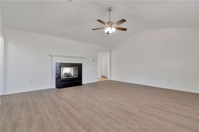 1740 Oxford Pl, Springdale, AR 72764 - unfurnished living room featuring a ceiling fan, vaulted ceiling, wood finished floors, a fireplace, and ornamental molding