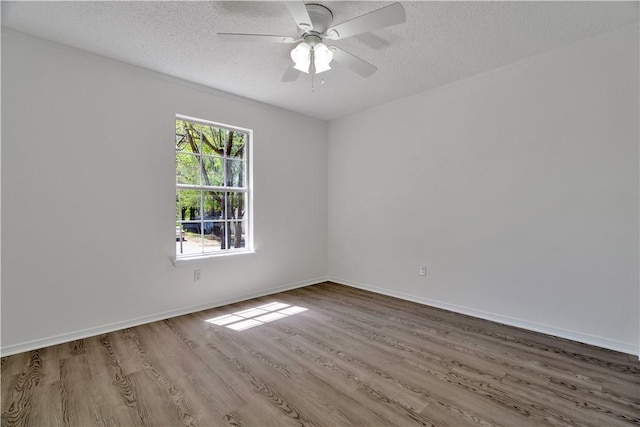 1740 Oxford Pl, Springdale, AR 72764 - empty room featuring wood finished floors, a textured ceiling, ceiling fan, and baseboards