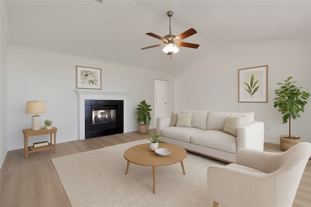 1740 Oxford Pl, Springdale, AR 72764 - living area featuring light wood-style flooring, a ceiling fan, lofted ceiling, a tiled fireplace, and baseboards