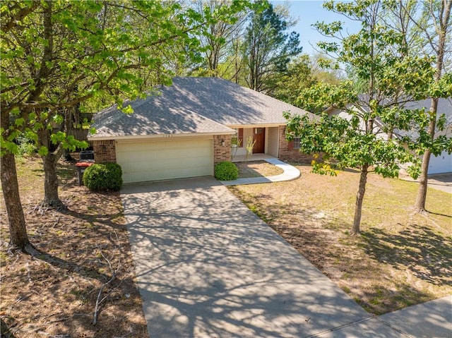 1765 Oxford Pl, Springdale, AR 72764 - view of front facade with brick siding, driveway, a garage, and a shingled roof