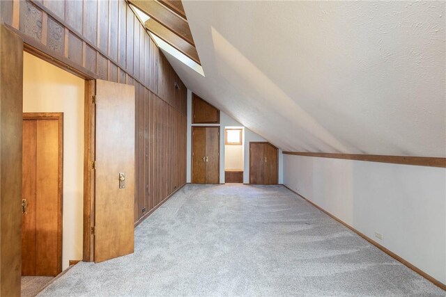 19584 Neills Bluff Rd, Springdale, AR 72764 - additional living space featuring vaulted ceiling, light colored carpet, and wood walls