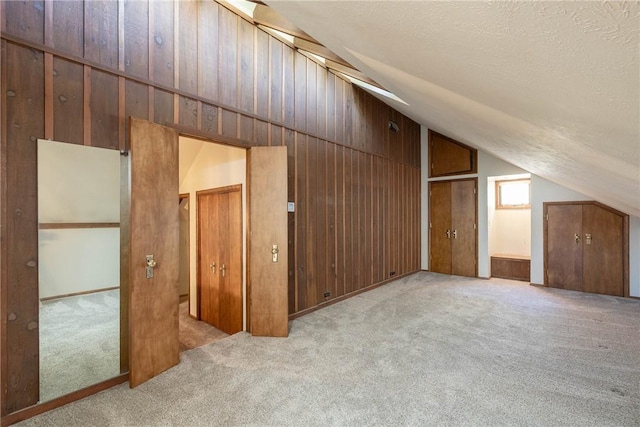 19584 Neills Bluff Rd, Springdale, AR 72764 - bonus room with vaulted ceiling, carpet floors, wooden walls, and a textured ceiling