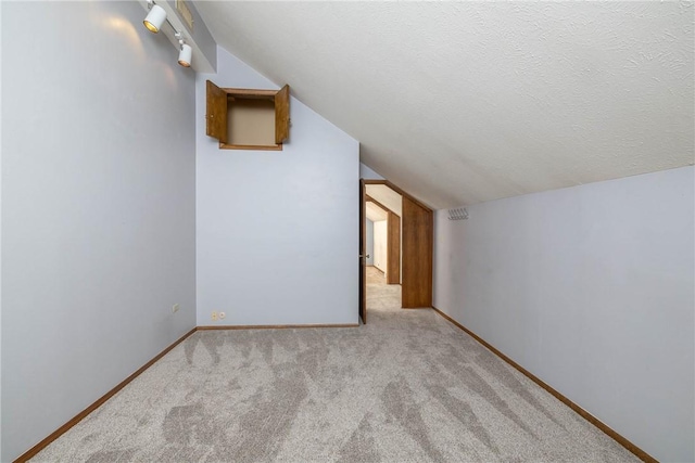 19584 Neills Bluff Rd, Springdale, AR 72764 - additional living space featuring vaulted ceiling, carpet flooring, and baseboards