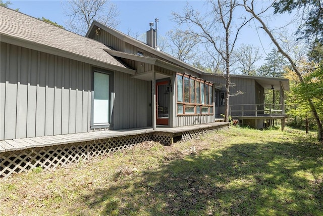 19584 Neills Bluff Rd, Springdale, AR 72764 - property entrance with a wooden deck, a shingled roof, a lawn, and a chimney