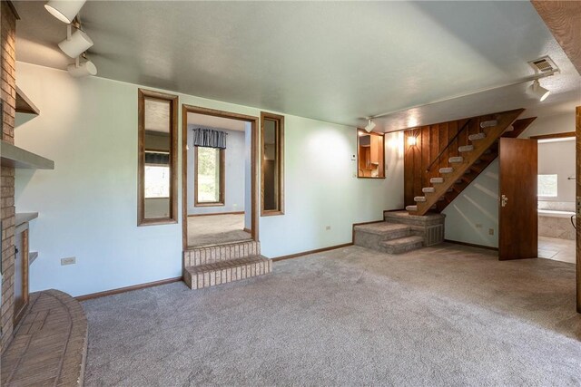 19584 Neills Bluff Rd, Springdale, AR 72764 - unfurnished living room featuring a fireplace, stairway, carpet floors, and baseboards