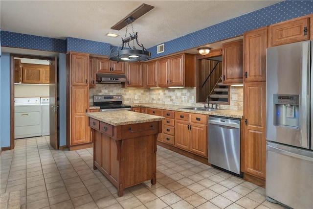 19584 Neills Bluff Rd, Springdale, AR 72764 - kitchen featuring appliances with stainless steel finishes, wallpapered walls, under cabinet range hood, a sink, and separate washer and dryer