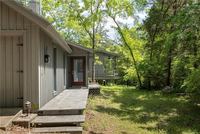 19584 Neills Bluff Rd, Springdale, AR 72764 - property entrance with board and batten siding, a chimney, and a lawn