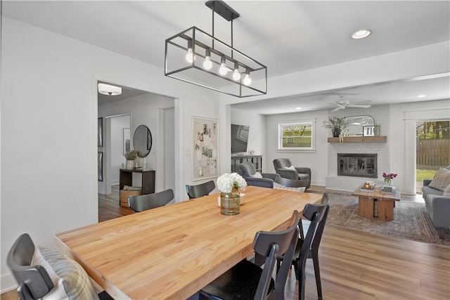 dining room with plenty of natural light, wood finished floors, and a fireplace