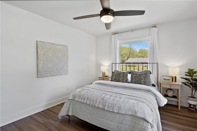 bedroom featuring wood finished floors, baseboards, and ceiling fan