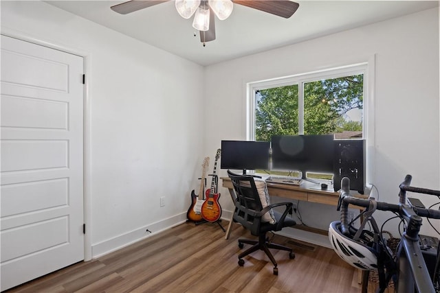 office area featuring ceiling fan, baseboards, and wood finished floors
