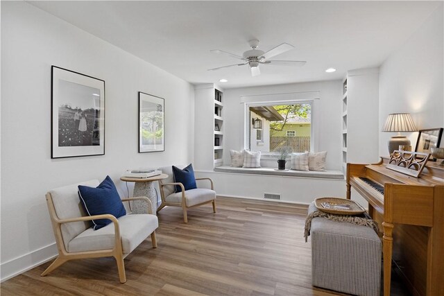 living area with wood finished floors, visible vents, recessed lighting, and a ceiling fan