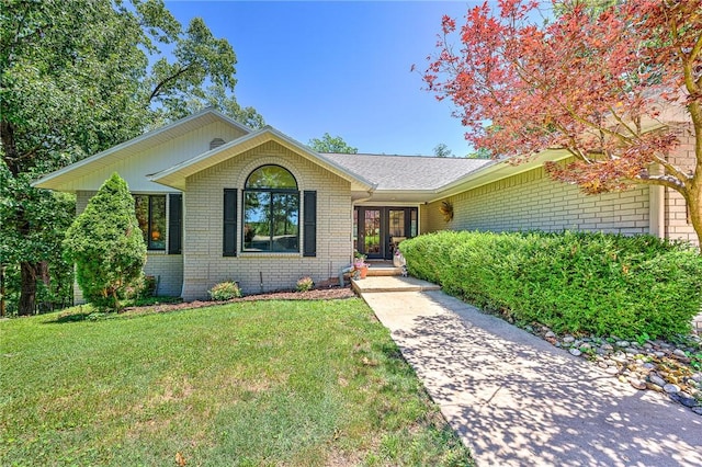 ranch-style home with a front lawn and brick siding