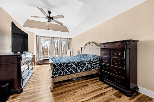 bedroom featuring baseboards, vaulted ceiling, a ceiling fan, and light wood-type flooring