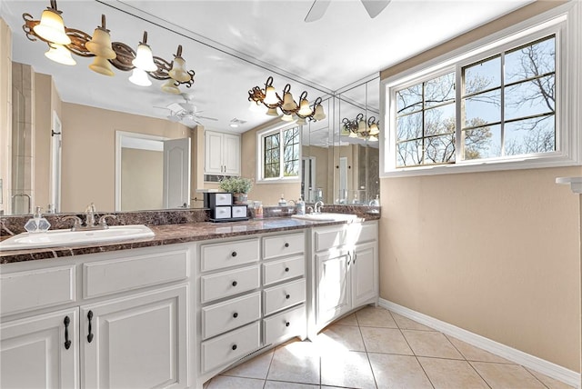 full bathroom featuring tile patterned floors, a ceiling fan, baseboards, and a sink