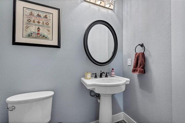 half bathroom featuring toilet