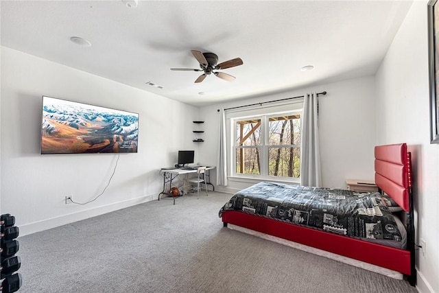 carpeted bedroom with visible vents, a ceiling fan, and baseboards