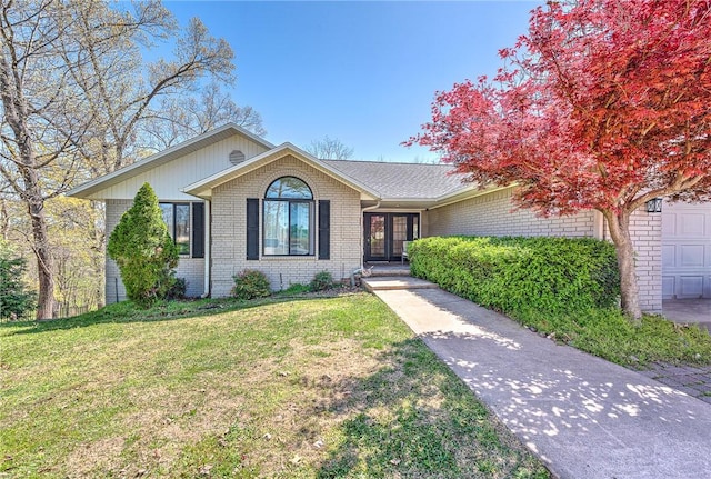 ranch-style house with brick siding and a front yard