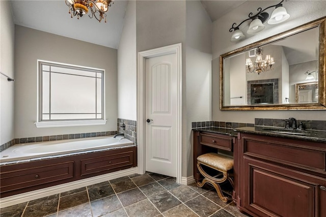bathroom with vanity, lofted ceiling, a bath, and a chandelier