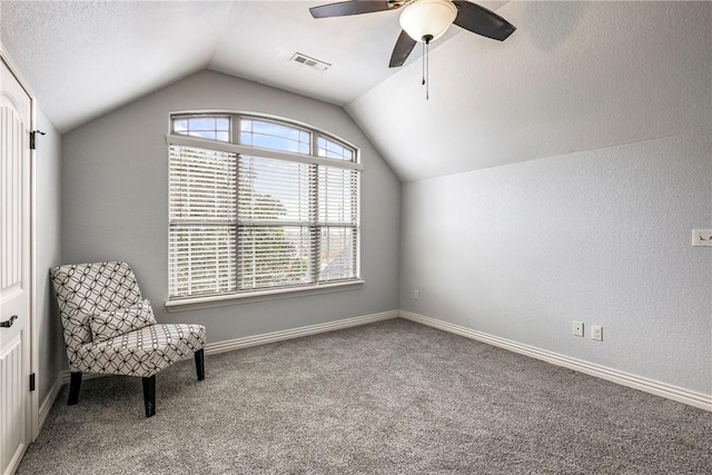 unfurnished room featuring carpet flooring, ceiling fan, baseboards, lofted ceiling, and visible vents