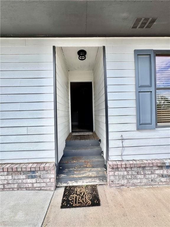 view of exterior entry featuring visible vents