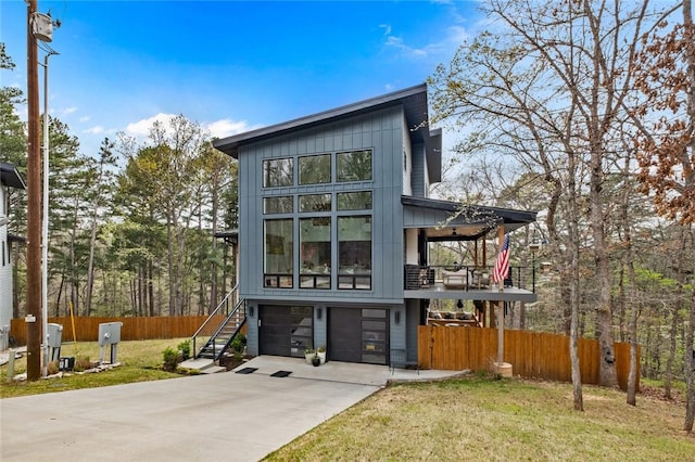4 Shap Ln, Bella Vista, AR 72714 - contemporary house featuring a balcony, driveway, a garage, board and batten siding, and stairs