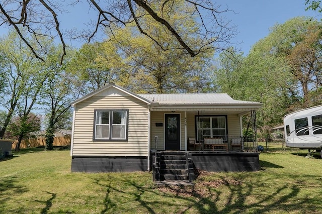 406 N Oak St, Harrison, AR 72601 - bungalow-style house with metal roof, a front lawn, covered porch, and fence