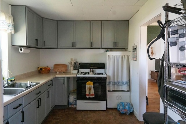 406 N Oak St, Harrison, AR 72601 - kitchen featuring gray cabinetry, white range with gas cooktop, light countertops, and a sink