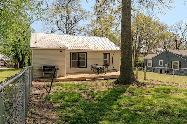 406 N Oak St, Harrison, AR 72601 - back of house with a fenced backyard, metal roof, a yard, and a deck