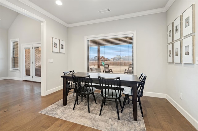dining area featuring baseboards, french doors, and wood finished floors