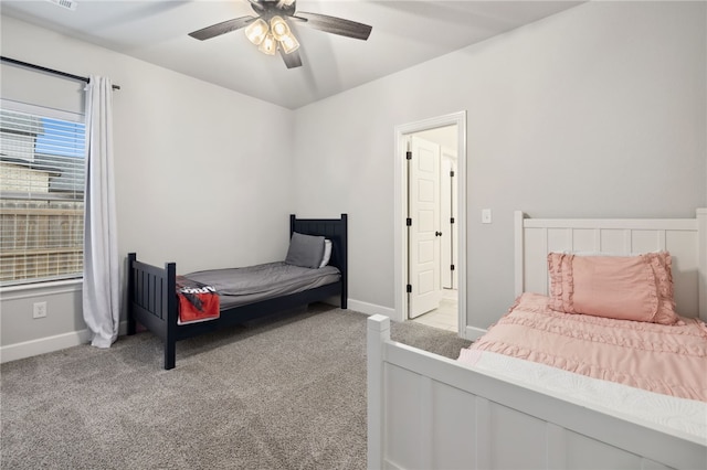 bedroom with ceiling fan, light colored carpet, and baseboards