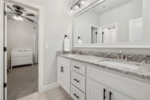 full bath with visible vents, a sink, ceiling fan, and double vanity
