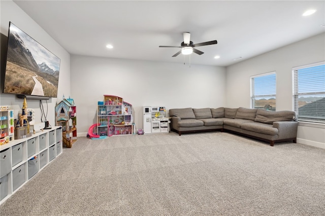 living area featuring carpet floors, recessed lighting, ceiling fan, and baseboards