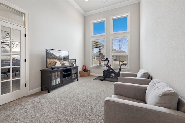sitting room with crown molding, carpet, baseboards, and a notable chandelier
