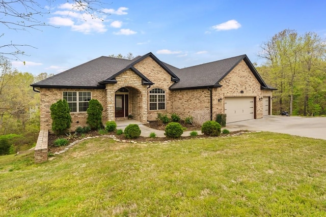 view of front of home with concrete driveway, an attached garage, brick siding, and a front yard