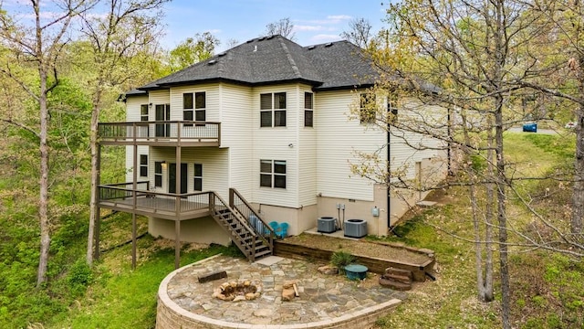 back of property with central air condition unit, stairs, a deck, a patio, and an outdoor fire pit